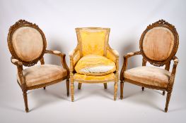 A pair of Victorian walnut open arm spoon-back chairs and one other.