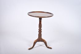 A Georgian mahogany turned pedestal tripod wine table. Possibly later top with molded edge.