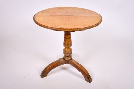 A 19th century oak tripod table.