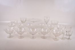A cut glass cake stand and an assortment of glasses.