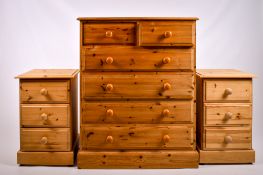 A contemporary pine chest of drawers and a pair of bedsides drawers.