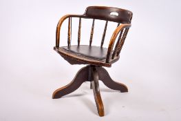 An early 20th century oak swivel bow-arm desk chair.