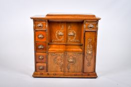 A cased cabinet Singer treadle sewing machine. In a carved oak cabinet.
