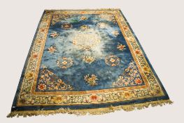 A large Chinese style wool rug carpet on a blue ground.