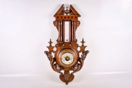 An early 20th century French beech cased wall mounted barometer and thermometer.