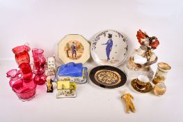 A collection of cranberry glass and assorted ceramic ornaments.