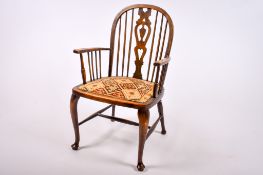 A late Victorian oak Windsor open armchair.