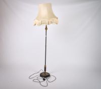 An early 20th century Japanned and gilt metal standard lamp with shade. Raised on a circular base.