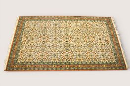 A decorative Turkish Gue Koyunlu wool rug on a cream ground.