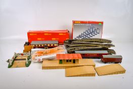 An assortment of 00 gauge carriages, rolling stock and layout accessories.
