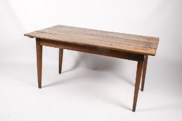 An English Farmhouse table. The plank top raised on square tapered supports, H72cm x W146.