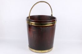 A George II or possibly later mahogany and brass bound peat bucket.