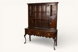 An Arts and Crafts stained oak dresser, in the Liberty style.