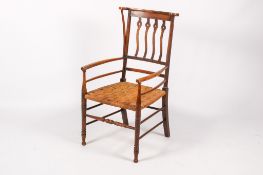 An early 20th century Arts and Crafts armchair.