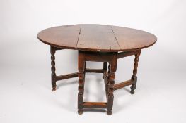 A 17th century oak drop leaf gate leg table.