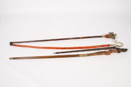 Four walking sticks constructed of various woods.