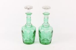 A pair of 20th century crystal decanters with green overlay.