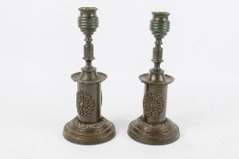 A pair of 19th century dark patinated bronze candlesticks.