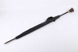 An early 20th century novelty umbrella with a Black Forest carved 'bulldog' handle.