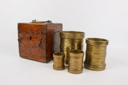 A boxed set of Country of Surrey District C Imperial Gill brass measures.