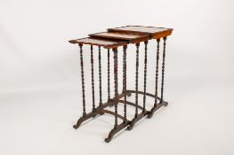 A nest of three 20th century rosewood occasional tables.