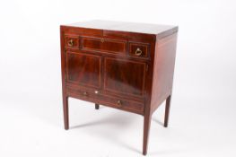 A George III mahogany and crossbanded foldout gentleman's dressing table.