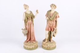 A pair of Royal Dux bisque porcelain classical figures.