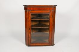 A Victorian mahogany corner bookcase cabinet.