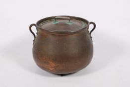 A large lidded copper cooking pot.