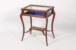 A 20th century mahogany bijouterie table display cabinet.