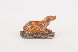 A Victorian salt glazed flat back pottery model of a dog.