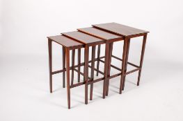 A vintage mahogany nest of four tables.