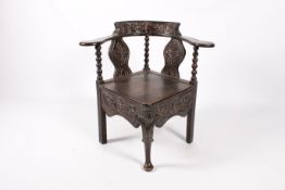 A late 19th century oak corner chair.