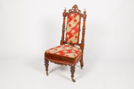 A Victorian heavily carved walnut prayer chair.