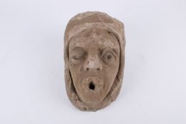 A gargoyle of a male head.