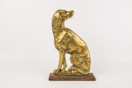 A Victorian brass door stopper.