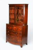 A 19th century inlaid mahogany secretaire bow fronted cabinet.