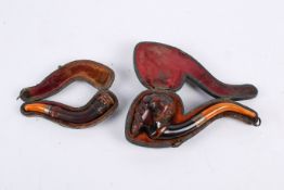 Two 19th century carved wood smoking pipes.