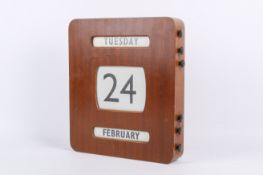 A vintage wall hanging perpetual calendar.