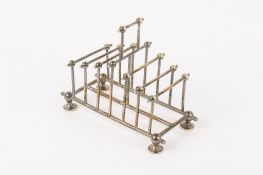 An Aesthetic silverplated toast rack in the manner of Christopher Dresser.