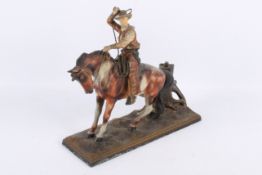 A 1920's cold painted spelter table lighter modelled as cowboy about to throw his lasso.