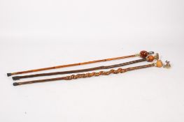 Three walking sticks constructed of various woods.