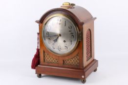 An early 20th century walnut cased Collingwood & Co chiming mantel clock.