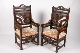 A pair of 19th century oak French Breton style armchairs.