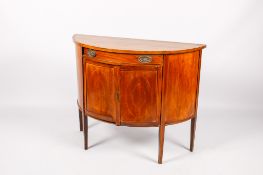 An early 20th century George III style mahogany and satinwood demilune side cabinet.