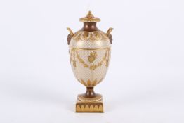 A late 19th/early 20th century Wedgwood gilt urn and cover.