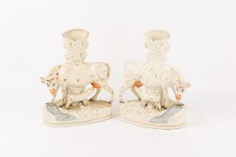 A pair of large 19th century Staffordshire cow and calf spill vases.