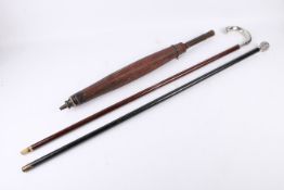 Two silver topped walking sticks and a parasol.