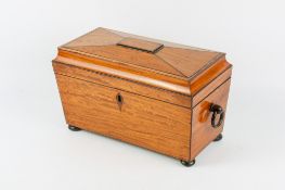 A 19th century satinwood tea caddy.