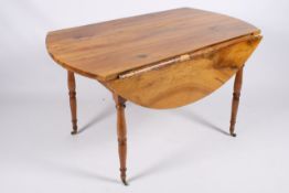 A 19th century and later French style fruitwood drop leaf dining table.